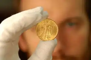 An appraiser inspecting a gold coin.